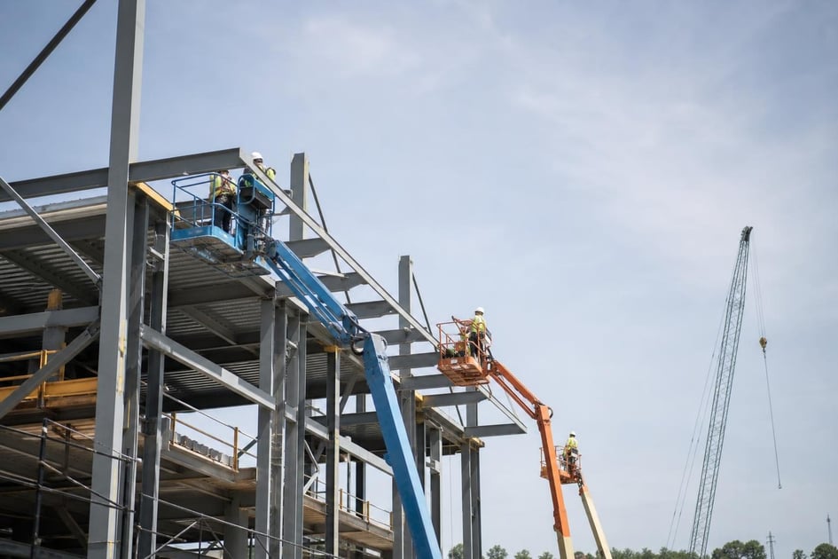 Articulating boom lift at a commercial worksite, illustrating boom lifts financing with no down payment: what to expect