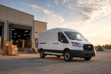 Used cargo van at a commercial worksite, illustrating cargo vans financing used: what to expect