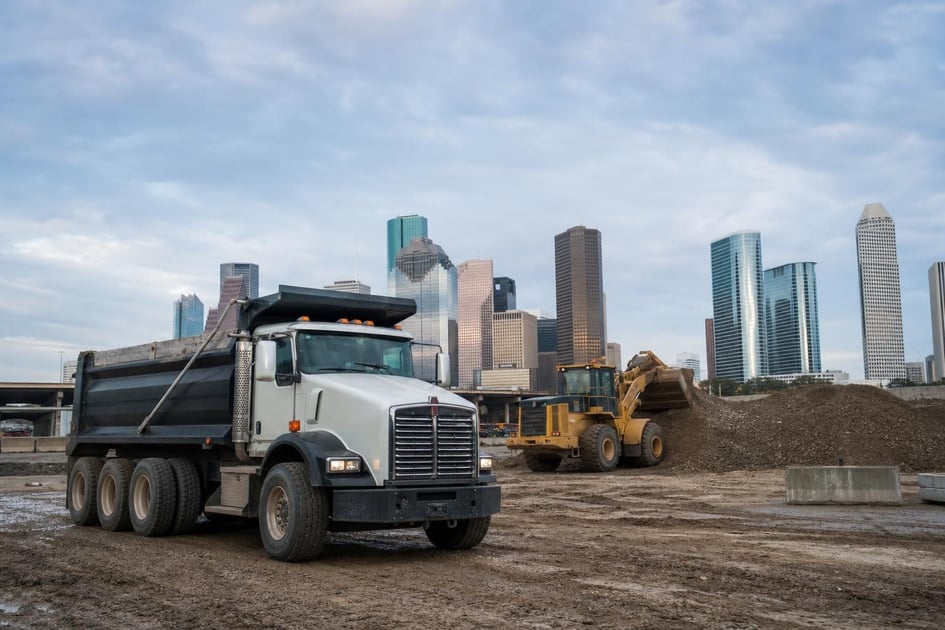 Dump truck at a commercial worksite, illustrating dump trucks financing in houston