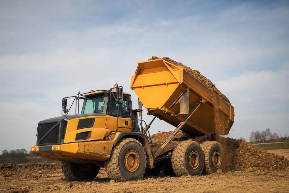 Dump trucks at a commercial worksite, illustrating dump trucks financing rates: what to expect