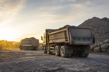 Dump trucks at a commercial worksite, illustrating dump trucks financing with no down payment: what to expect