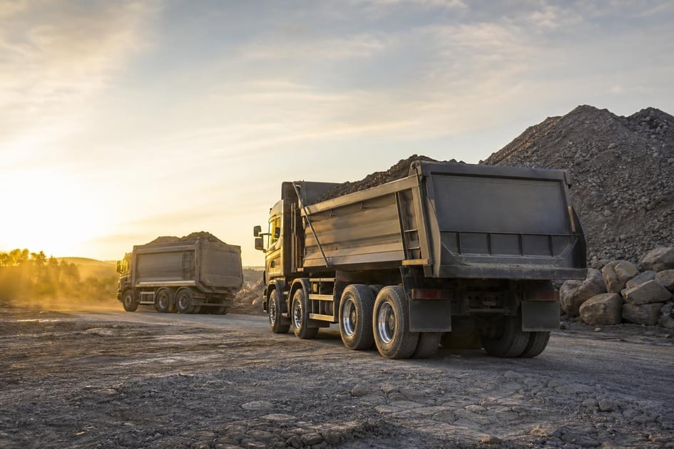 Dump trucks at a commercial worksite, illustrating dump trucks financing with no down payment: what to expect