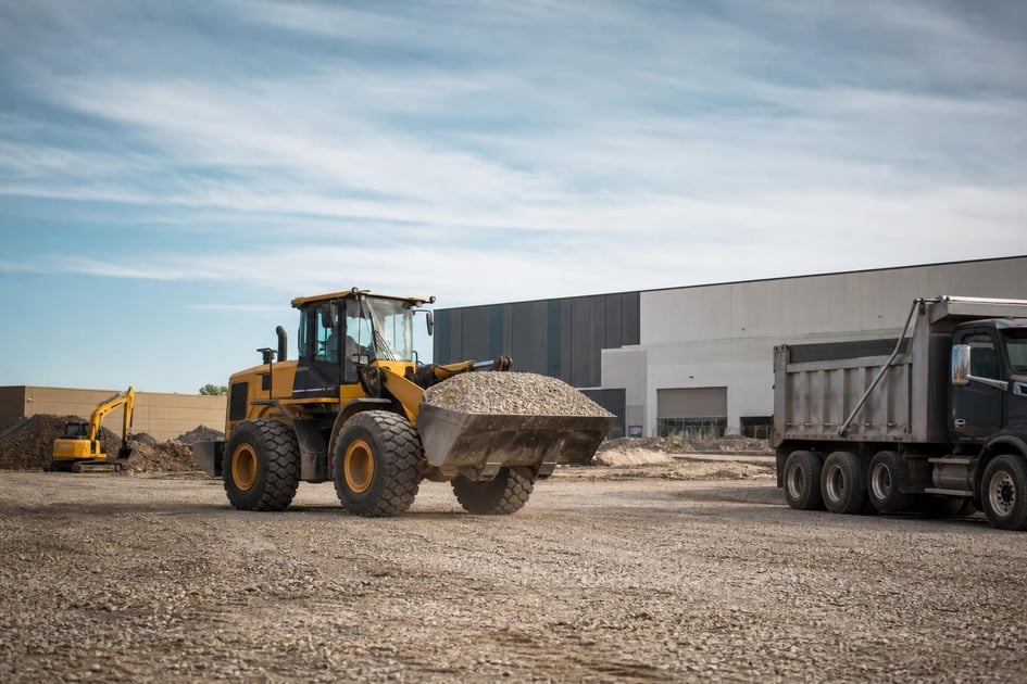 Skid steer loader at a commercial worksite, illustrating equipment financing in wisconsin: rates, terms and how to qualify