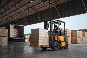 Used forklift at a commercial worksite, illustrating forklifts financing used: what to expect