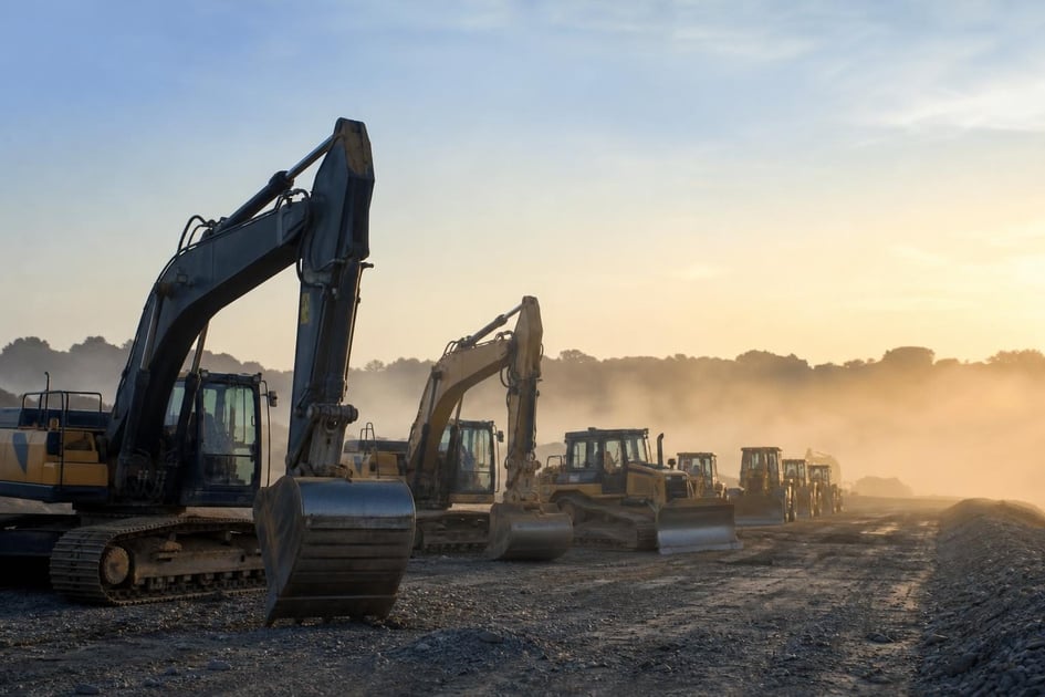 Heavy construction equipment at a commercial worksite, illustrating operating lease vs capital lease: which is right for your business?