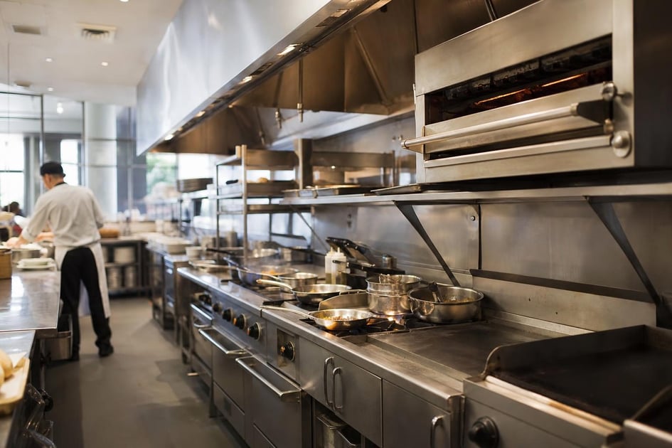Commercial kitchen line at a commercial worksite, illustrating restaurant food service equipment financing requirements