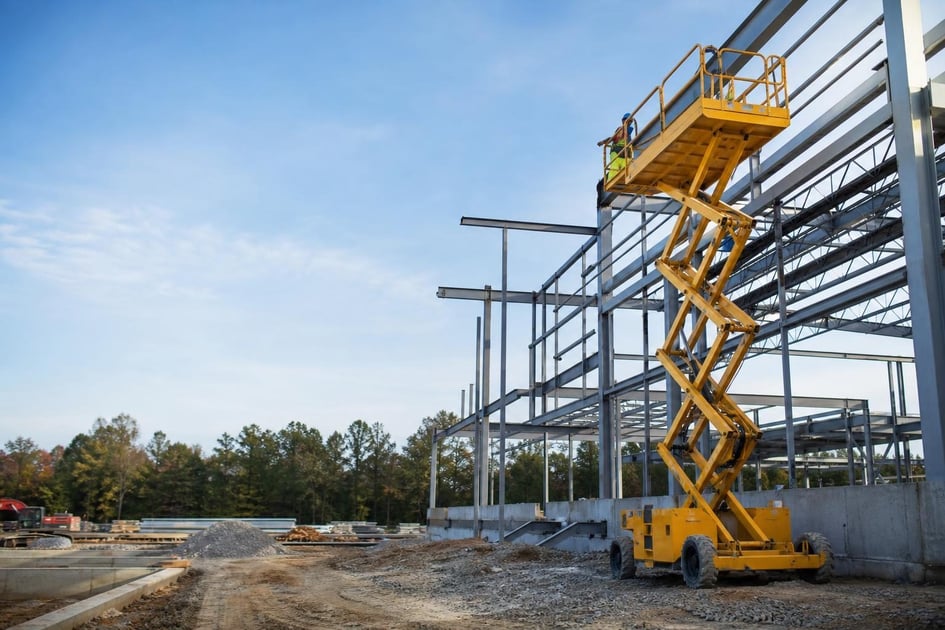 Scissor lift at a commercial worksite, illustrating scissor lifts financing in georgia