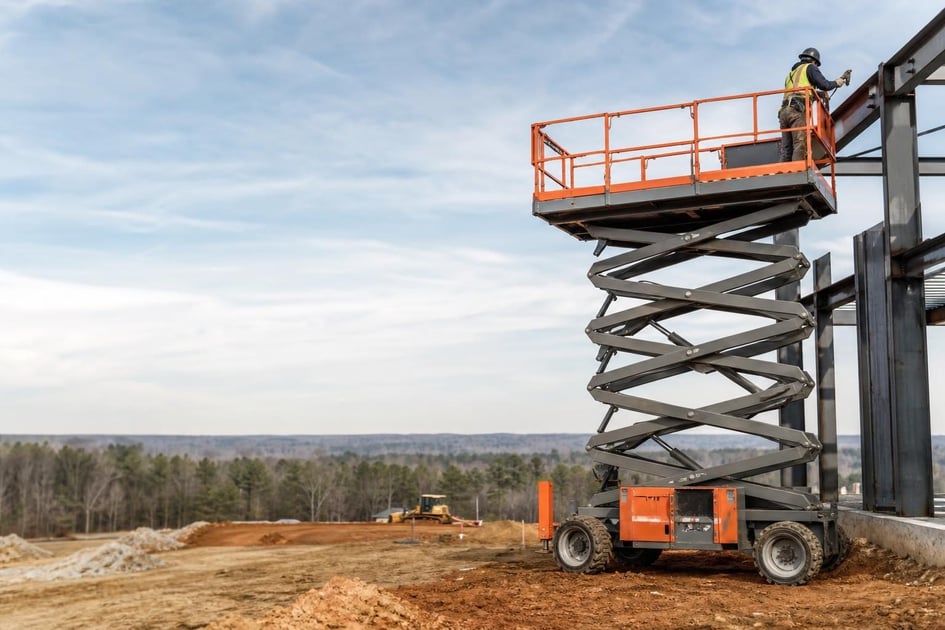 Scissor lifts at a commercial worksite, illustrating scissor lifts financing in north carolina