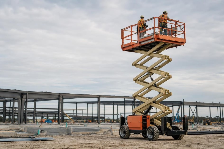 Scissor lifts at a commercial worksite, illustrating scissor lifts financing qualify for: what to expect