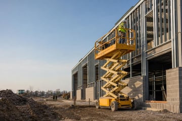 Scissor lift at a commercial worksite, illustrating scissor lifts financing rates: what to expect