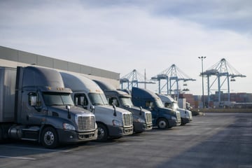 Semi trucks at a commercial worksite, illustrating semi trucks financing in california