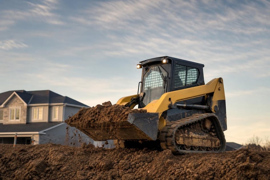 Skid steer loader at a commercial worksite, illustrating skid steers financing bad credit: what to expect