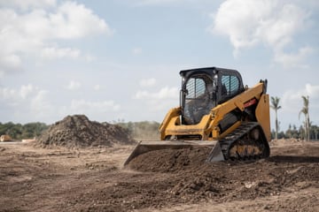 Skid steer loader at a commercial worksite, illustrating skid steers financing in florida