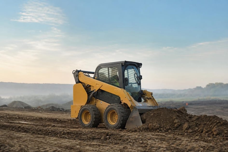 Skid steer loader at a commercial worksite, illustrating skid steers financing rates: what to expect