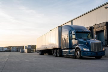 Semi-truck and trailer at a commercial worksite, illustrating transportation equipment financing qualify for