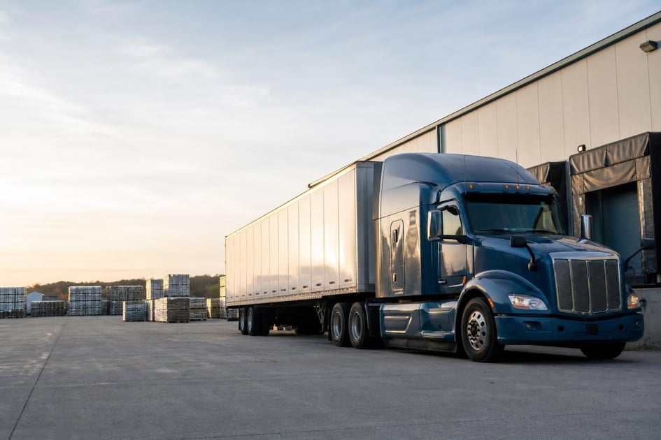 Semi-truck and trailer at a commercial worksite, illustrating transportation equipment financing qualify for