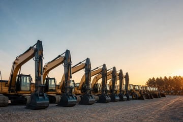 Equipment dealership inventory at a commercial worksite, illustrating vendor financing program for dealers