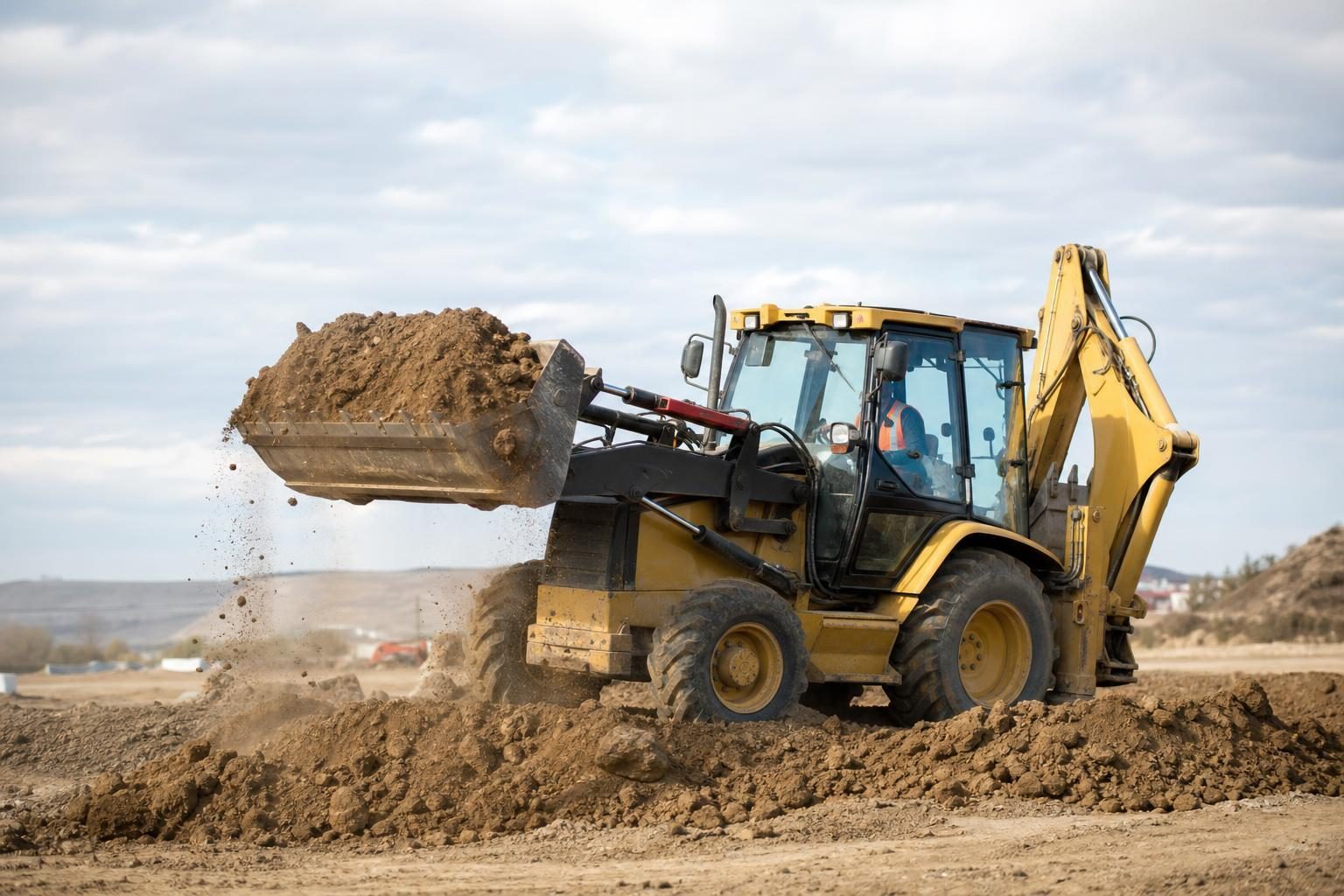 Backhoe loader at a commercial worksite, illustrating backhoes financing no money down: what to expect