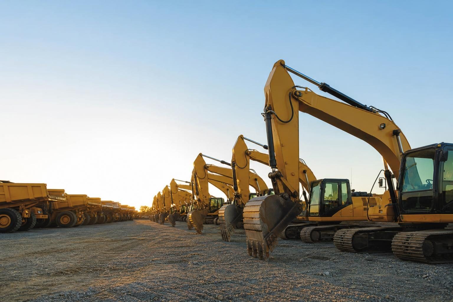 Heavy equipment on a dealer lot at a commercial worksite, illustrating equipment dealer financing program
