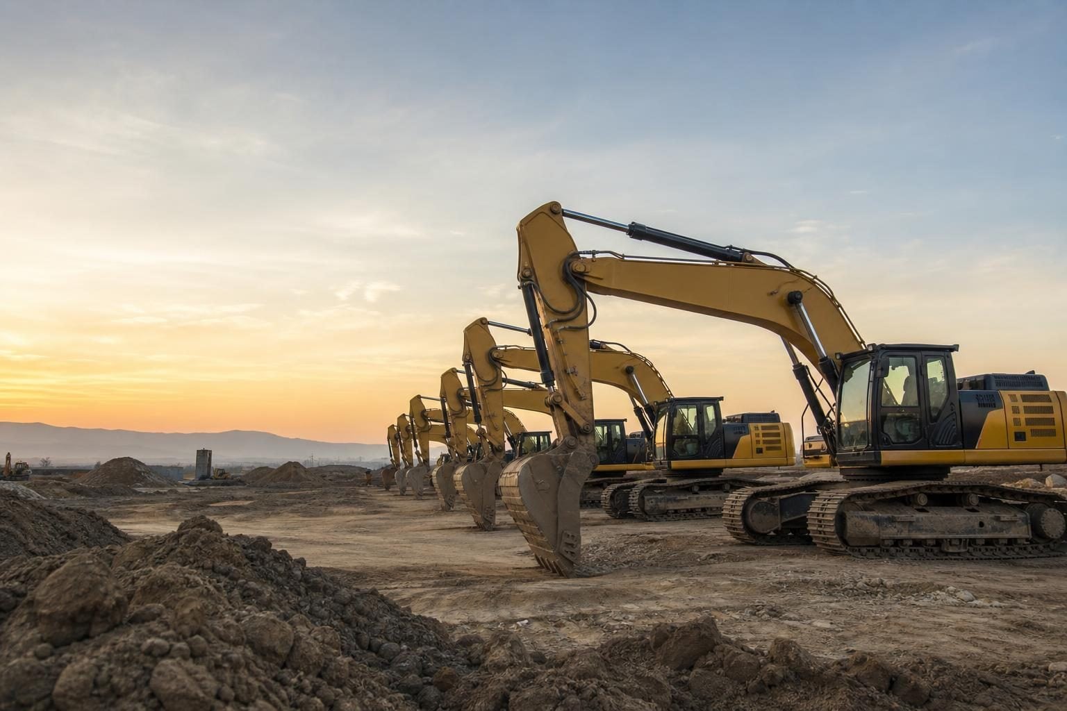 Excavators at a commercial worksite, illustrating heavy equipment financing: complete guide